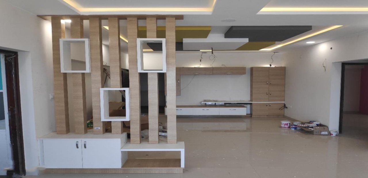 Completed living room with wooden partition and TV unit by Wood Instincts