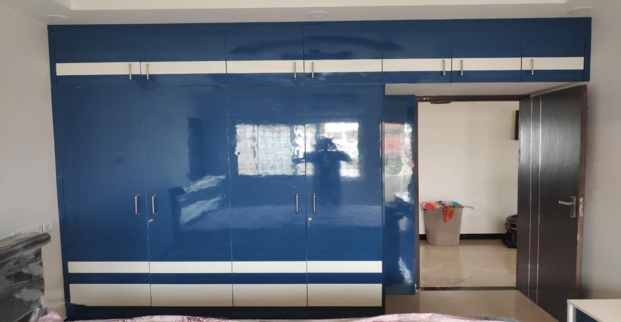 High-Gloss Blue Wardrobe — bedroom interior design in Chennai